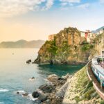 Manarola, Cinque Terre - train station in small village with colorful houses on cliff overlooking sea. Cinque Terre National Park with rugged coastline is famous tourist destination in Liguria, Italy
