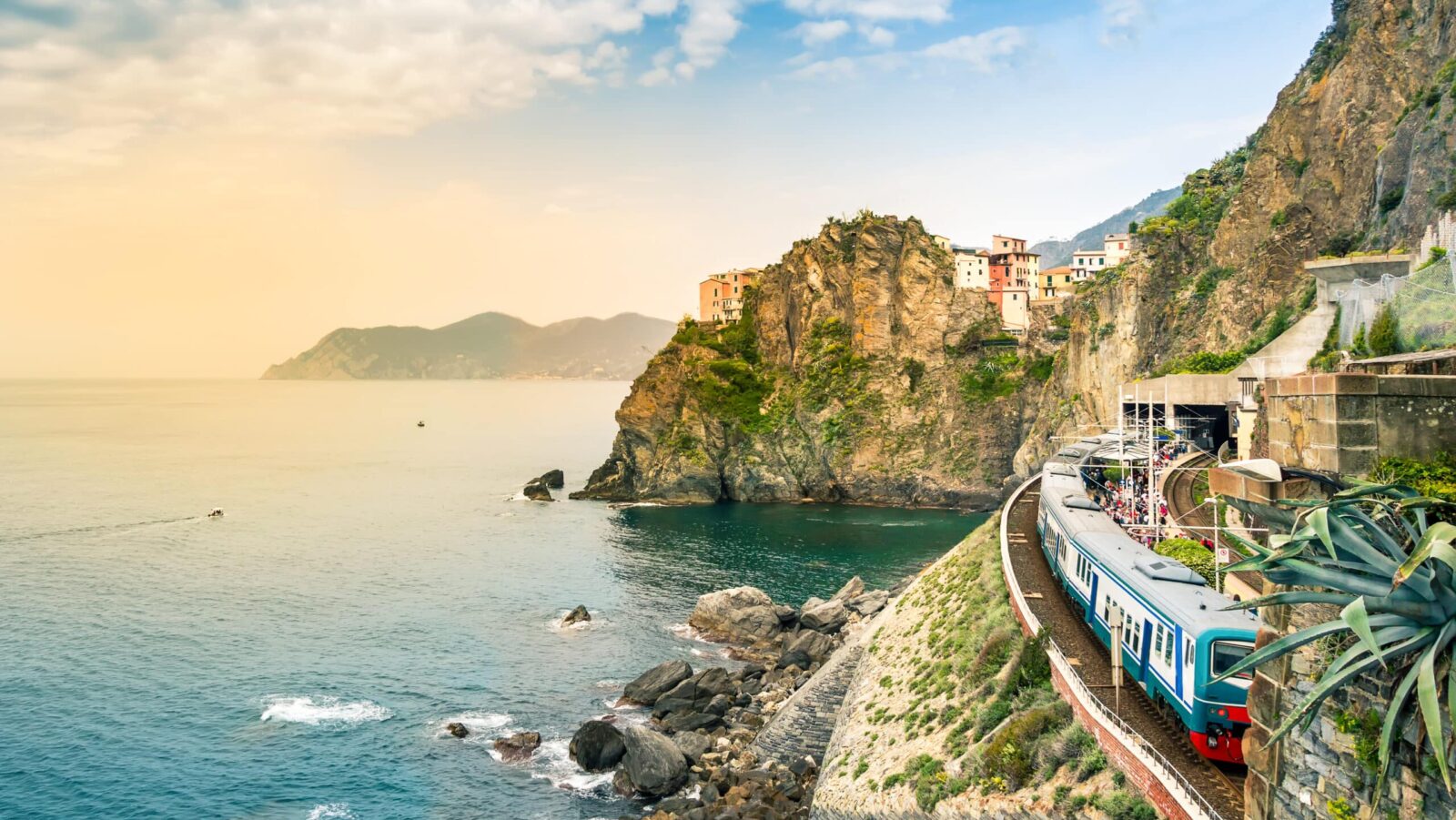 Manarola, Cinque Terre - train station in small village with colorful houses on cliff overlooking sea. Cinque Terre National Park with rugged coastline is famous tourist destination in Liguria, Italy