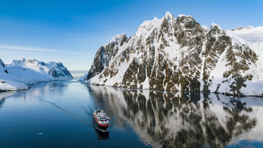 An HX Expeditions ship travels through the Lemaire Channel on an Antarctica cruise