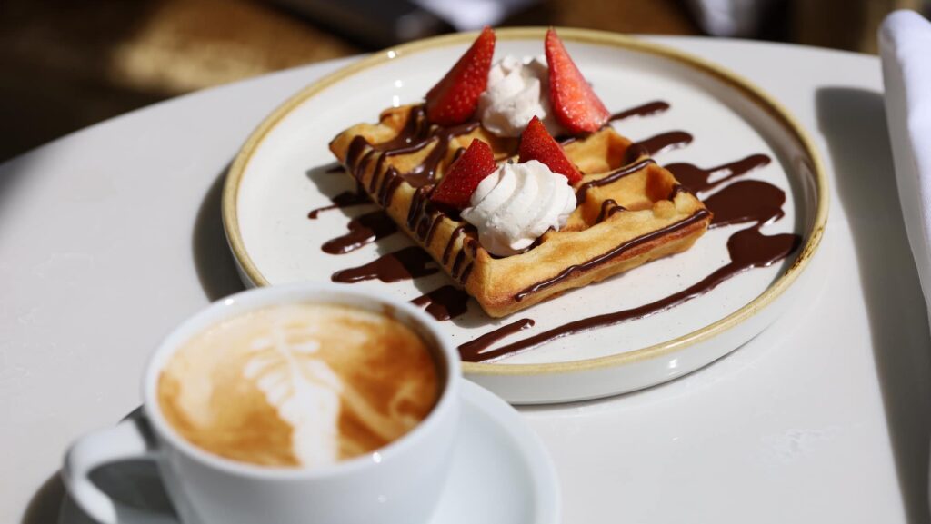 Coffee and a waffle at La Creperie on the Oceania Allura ship