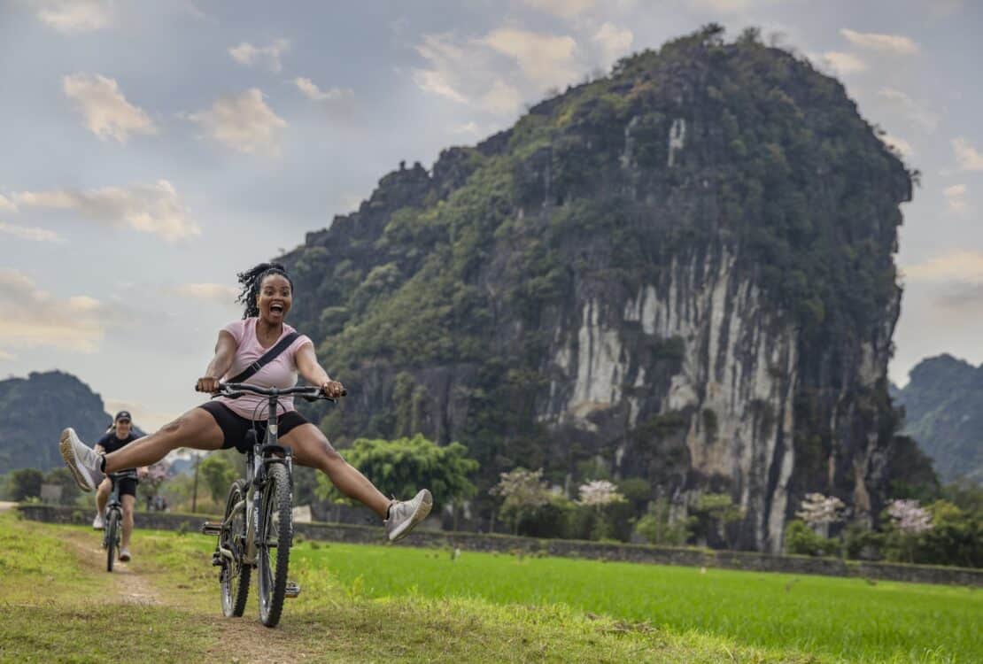 A woman riding a bike on a G Adventures tour in Vietnam