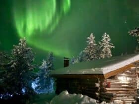 Northern Lights over a cabin at a hotel in northern Finland
