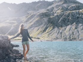 A woman walking barefoot in a mountain lake in Austria