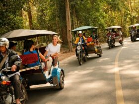 Four tuk tuks transporting travelers on Contiki's new Ride Cambodia tour