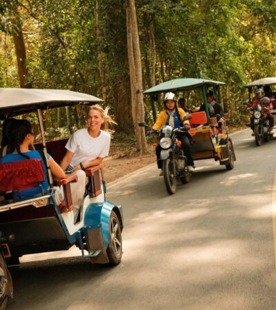 Four tuk tuks transporting travelers on Contiki's new Ride Cambodia tour