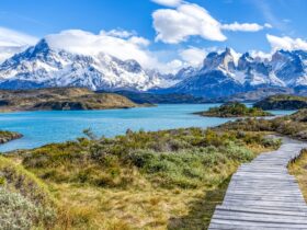 A wooden walkway leading to Pehoe Lake with the Cuernos Peaks in the background at Torres del Paine National Park in Chile