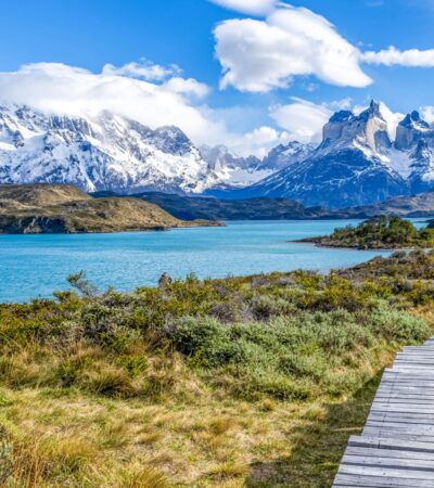 A wooden walkway leading to Pehoe Lake with the Cuernos Peaks in the background at Torres del Paine National Park in Chile