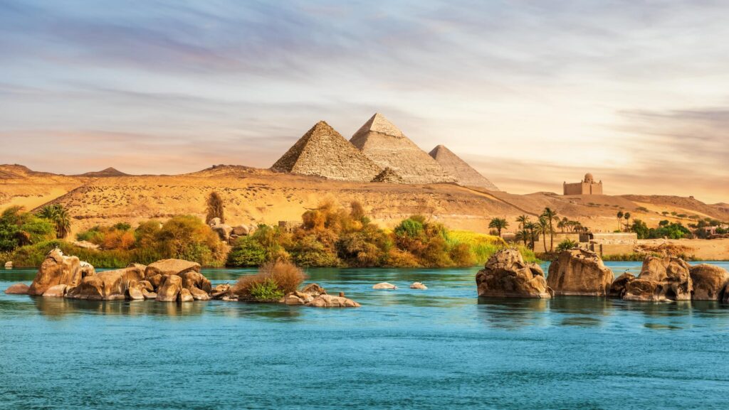 The Nile River and ancient rocks in the Aswan desert by the pyramids in Egypt