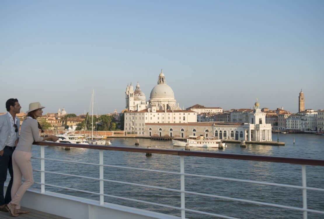 Two people on a ship overlooking Venice