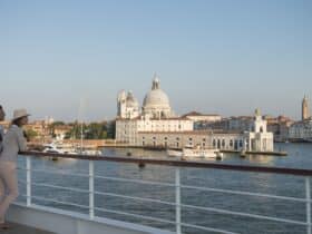 Two people on a ship overlooking Venice